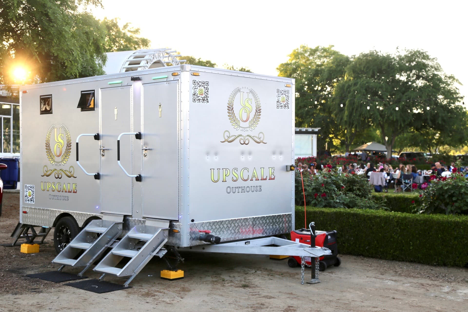 Upscale Outhouse luxury restroom trailer at a winery event during golden hour