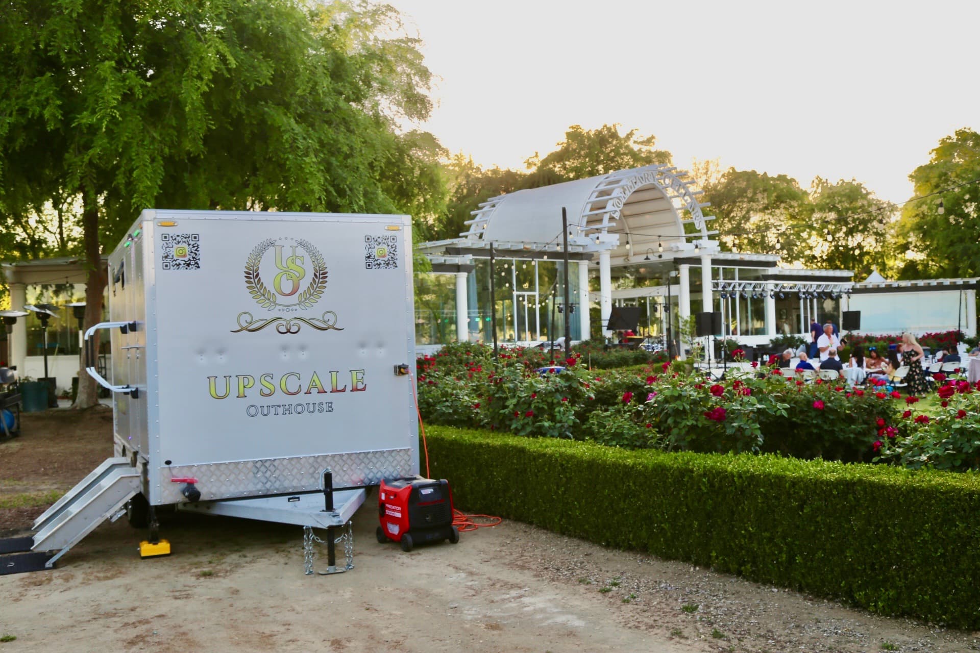 Upscale Outhouse trailer at a winery wedding with roses and pavilion